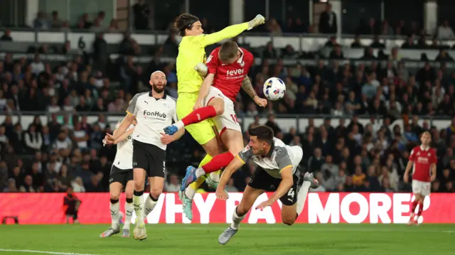 Derby keeper Jacob Widell Zetterstrom punches the ball clear