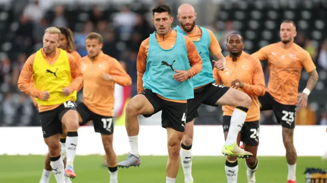 Derby players warm up