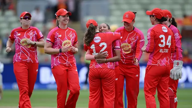 Shabnim Ismail of Welsh Fire is congratulated by team mate Tammy Beaumont after taking the wicket of Ellyse Perry