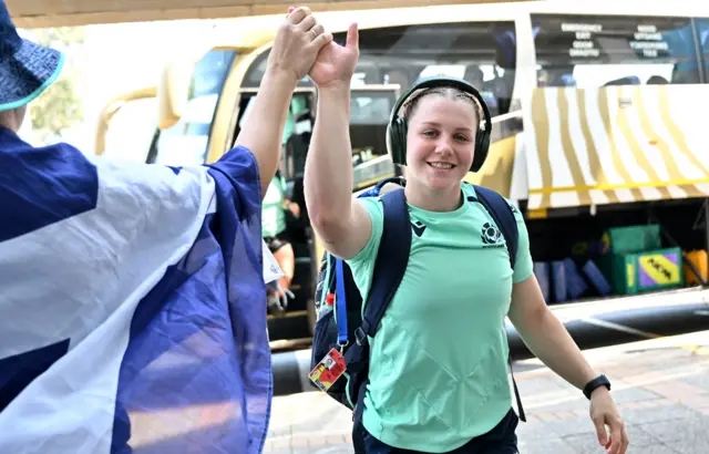 Alex Stewart greets a Scotland fan when getting off the team bus