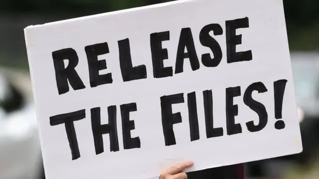 A sign reads 'Release the files'. The background is blurred