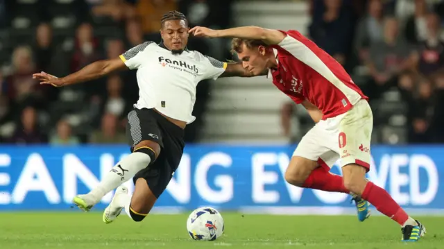 Rhian Brewster and Scott Twine battle for the ball