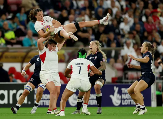 Abbie Ward of England catches the ball with support from teammate Maud Muir