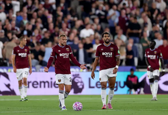 Jarrod Bowen and Lucas Paqueta of West Ham United react after Enzo Fernandez of Chelsea (not pictured) scored his team's third goal during the Premier League match between West Ham United and Chelsea at London Stadium on August 22, 2025 in London, England.