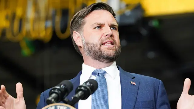 JD Vance speaking at a podium