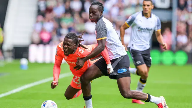 David Ozoh of Derby tackled Brandon Thomas-Asante of Coventry