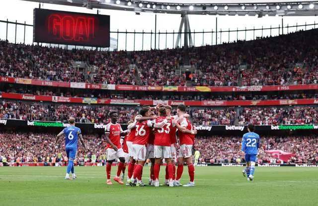 Arsenal players celebrate one of their goals v Leeds