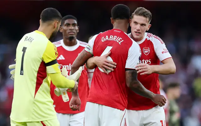 Arsenal players celebrate their win at full time