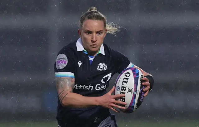Chloe Rollie running with the ball for Scotland