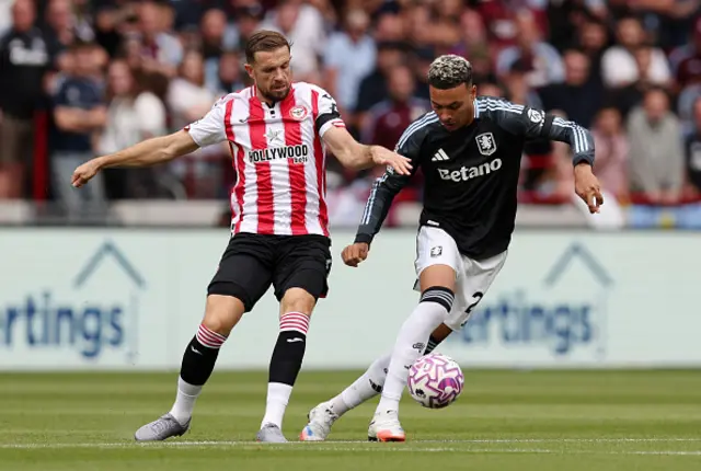 Morgan Rogers of Aston Villa is challenged by Jordan Henderson