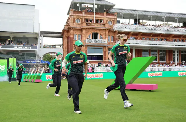 Chloe Tyron and Lauren Bell of Southern Brave walk out to field prior to the The Hundred match between London Spirit Women and Southern Brave Women at Lord's Cricket Ground on August 23, 2025 in London, England.