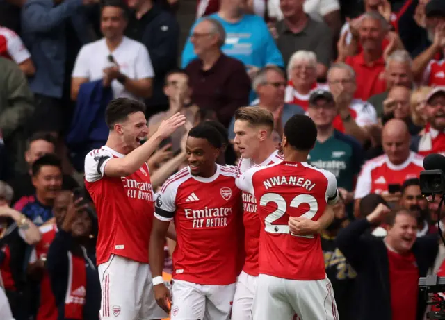 Timber is congratulated by his teammates on his second goal