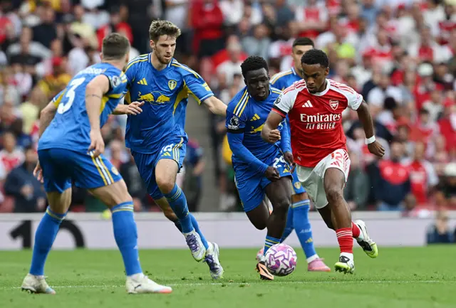 Timber runs through a crowd of bodies with the ball