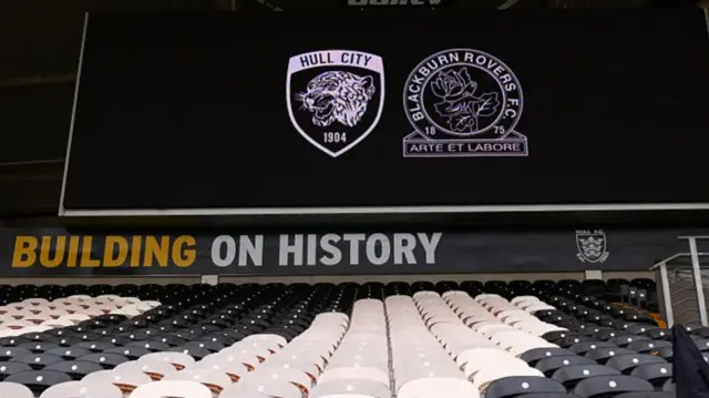 A video screen with Hull and Blackburn crests