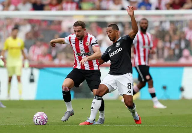 Jordan Henderson of Brentford battles for possession with Youri Tielemans