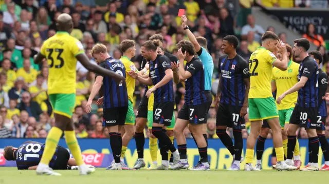 Norwich's Jacob Wright is shown a red card