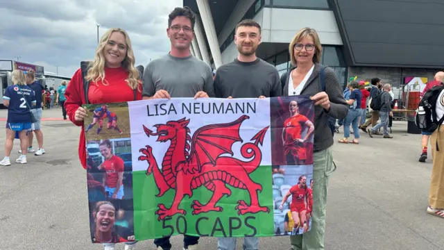Lisa Neumann's family with a Wales flag