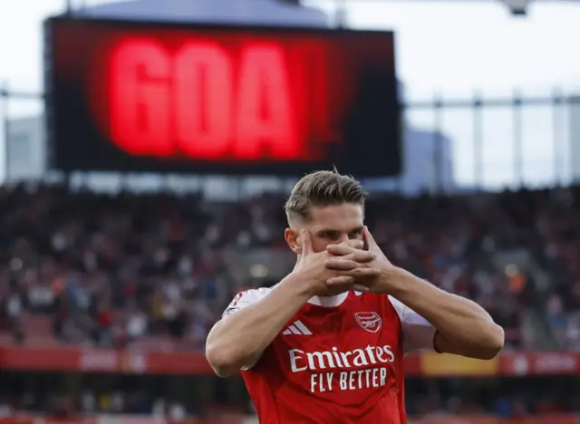 Gyokeres does his mask celebration as the scoreboard has 'GOAL' written on it behind him