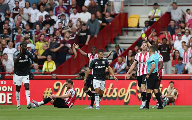 Amadou Onana of Aston Villa is shown a yellow card