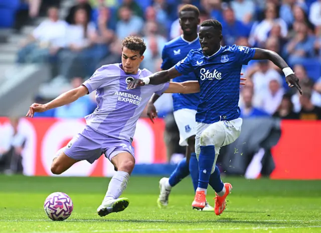 Olivier Boscagli of Brighton & Hove Albion battles for possession with Idrissa Gana Gueye