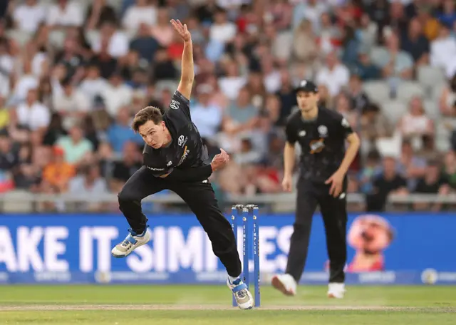 Sonny Baker of Manchester Originals bowls during the The Hundred match between Manchester Originals Men and Birmingham Phoenix Men at Emirates Old Trafford on August 24, 2025 in Manchester, England.