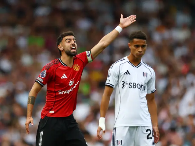 Fernandes shouts and waves his arms