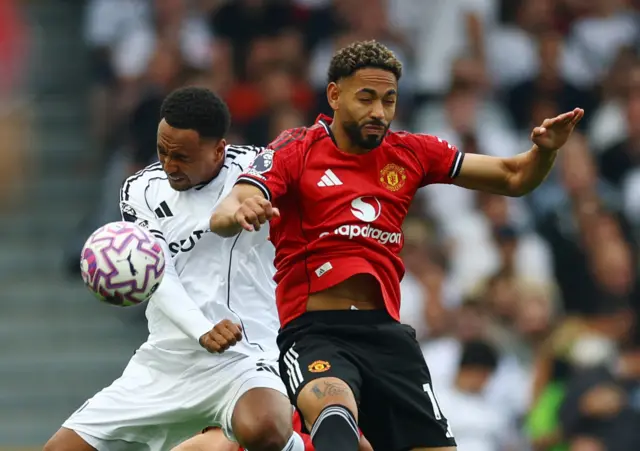 Cunha and King battle for the ball in midfield