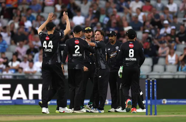 Sonny Baker of Manchester Originals celebrates the wicket of Will Smeed of Birmingham Phoenix with teammates during the The Hundred match between Manchester Originals Men and Birmingham Phoenix Men at Emirates Old Trafford on August 24, 2025 in Manchester, England.