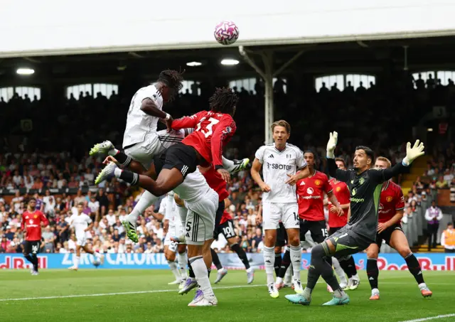 Bayindir makes himself big as players go for a header in front of him