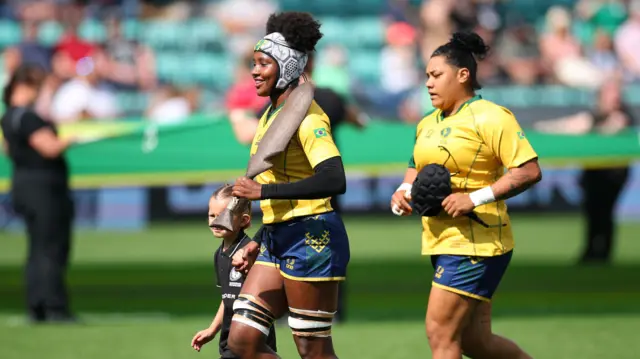 Brazil's Eshyllen Coimbra carrying a Upepe onto the pitch before the match
