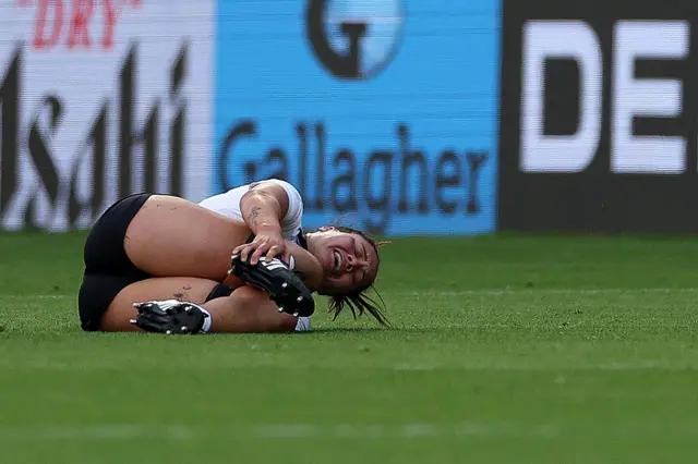 Kaipo Olsen-Baker on the floor clutching her leg.