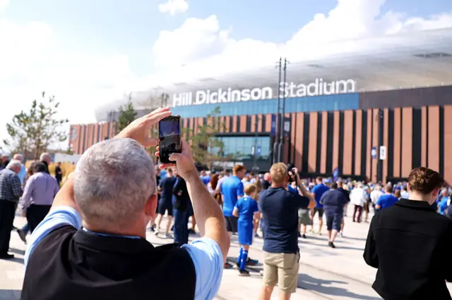 Man taking picture of the Hill Dickinson Stadium