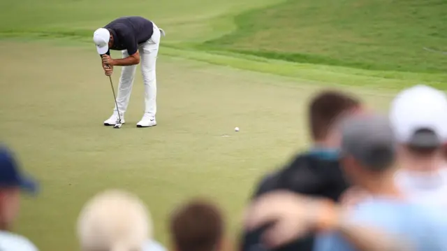 Scottie Scheffler reacts to a missed putt during round three