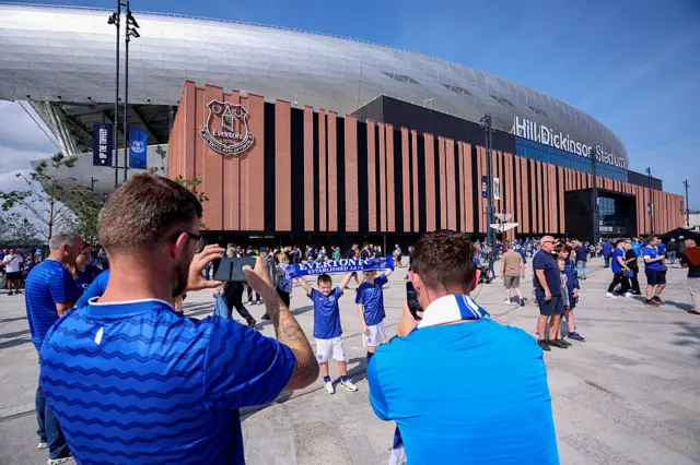 Everton fans taking pictures in front of the Hill Dickinson Stadium