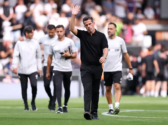 Silva waves at the fans as he walks across the pitch to the dugout