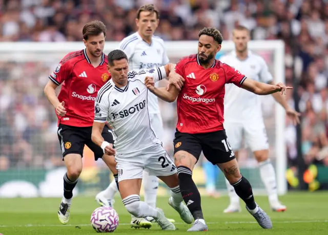 Cunha and Lukic battle for the ball in midfield