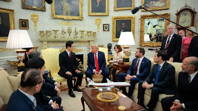 President Donald Trump (centre) meets with President of South Korea Lee Jae Myung in the Oval Office at the White House. They are flanked on each side by their respective cabinet members and interpreters.