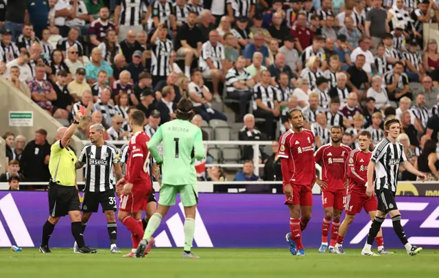NEWCASTLE UPON TYNE, ENGLAND - AUGUST 25: Anthony Gordon of Newcastle United is shown a red card
