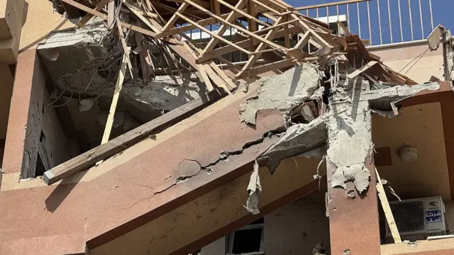 A general view of the damaged Nasser Medical Complex building as injured Palestinians are taken to Nasser Hospital by local residents following Israeli attacks on the Nasser Medical Complex in Khan Yunis
