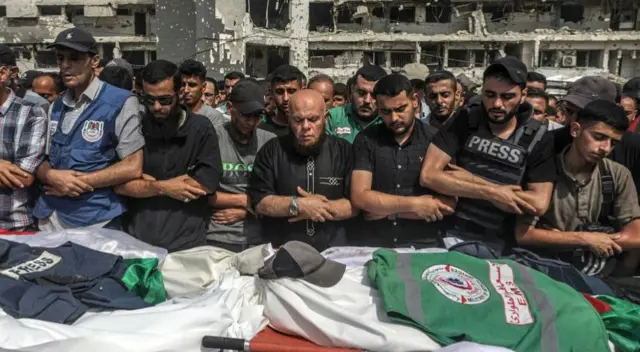 Palestinians attend the funeral of journalists killed in an Israeli strike, outside Al-Shifa Hospital in Gaza City, 11 August 2025