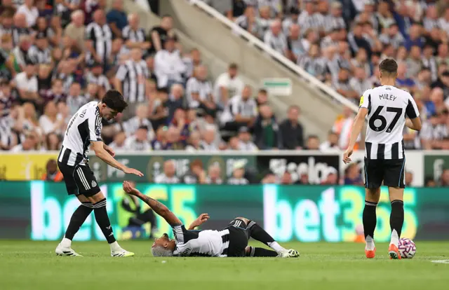 Joelinton of Newcastle United goes down with an injury
