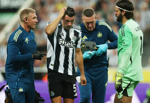 Newcastle United's Fabian Schar receives medical attention after sustaining an injury