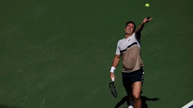 Federico Agustin Gomez serves against Jack Draper