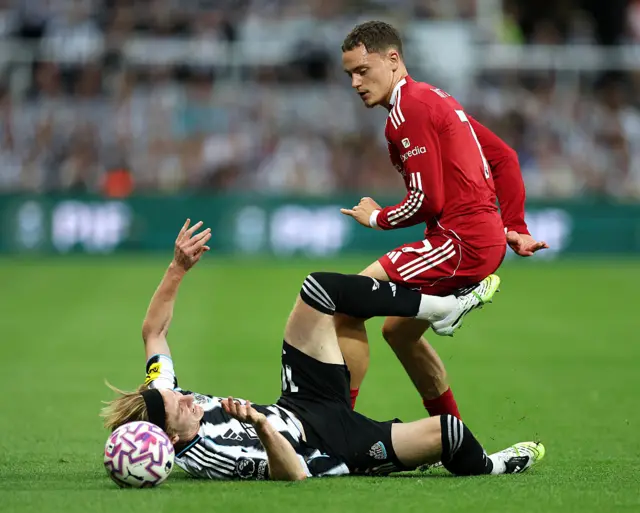 Anthony Gordon of Newcastle United is fouled by Florian Wirtz of Liverpool during the Premier League match between Newcastle United and Liverpool at St James' Park on August 25, 2025 in Newcastle upon Tyne, England.
