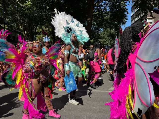 A side view of dancers walking through the parade