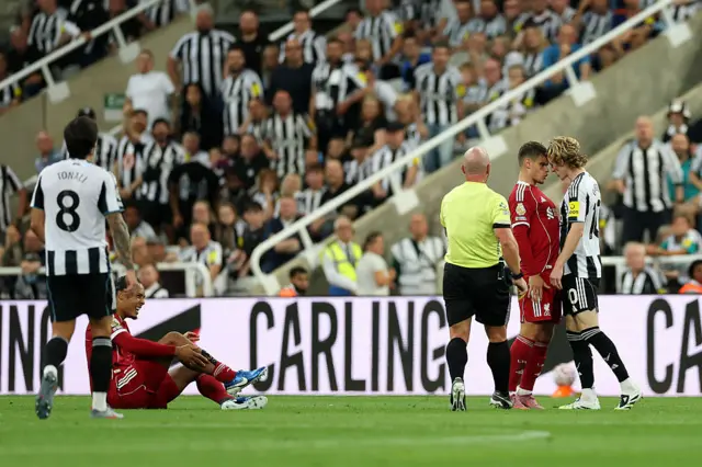 Milos Kerkez of Liverpool clashes with Anthony Gordon of Newcastle United as Virgil van Dijk of Liverpool reacts after being fouled during the Premier League match between Newcastle United and Liverpool at St James' Park on August 25, 2025 in Newcastle upon Tyne, England.