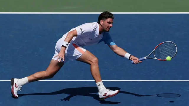 Cameron Norrie of the United Kingdom returns a shot against Sebastian Korda of the United States