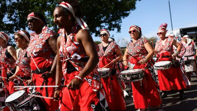 Revellers play drums as they take part in the Notting Hill Carnival in London,