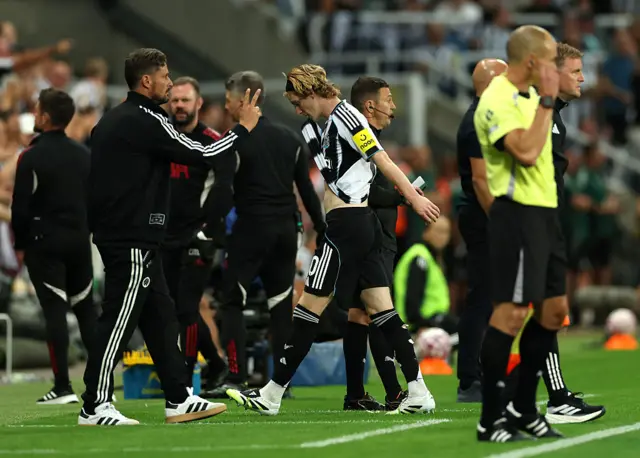 NEWCASTLE UPON TYNE, ENGLAND - AUGUST 25: Anthony Gordon of Newcastle United leaves the field having being shown a red card by referee Simon Hooper (not pictured) after an on-field VAR review overturns the decision to award a yellow card for a foul on Virgil van Dijk of Liverpool