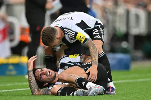 Newcastle United's Italian midfielder #08 Sandro Tonali reacts after picking up an injury